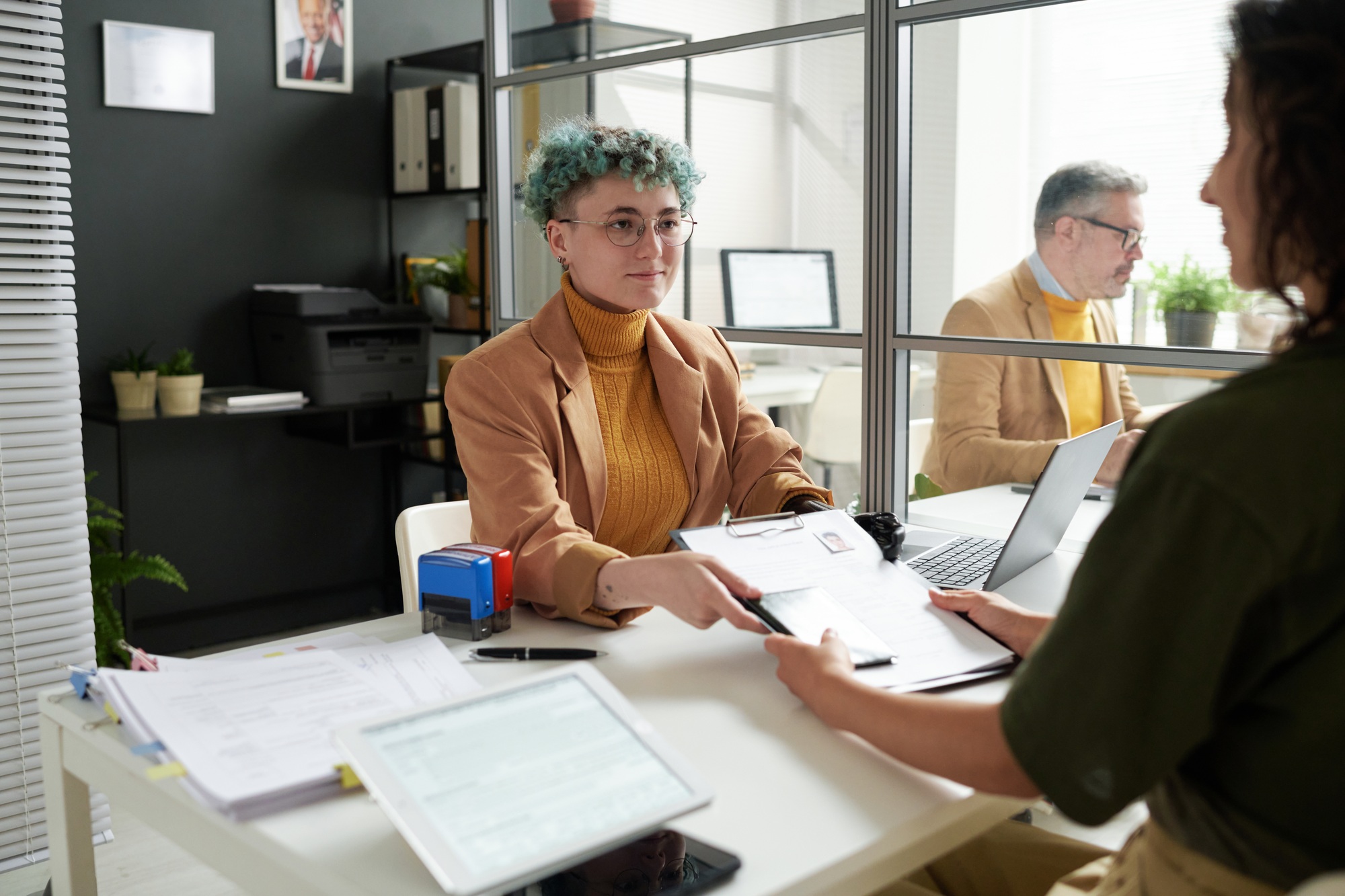 Manager giving documents to woman