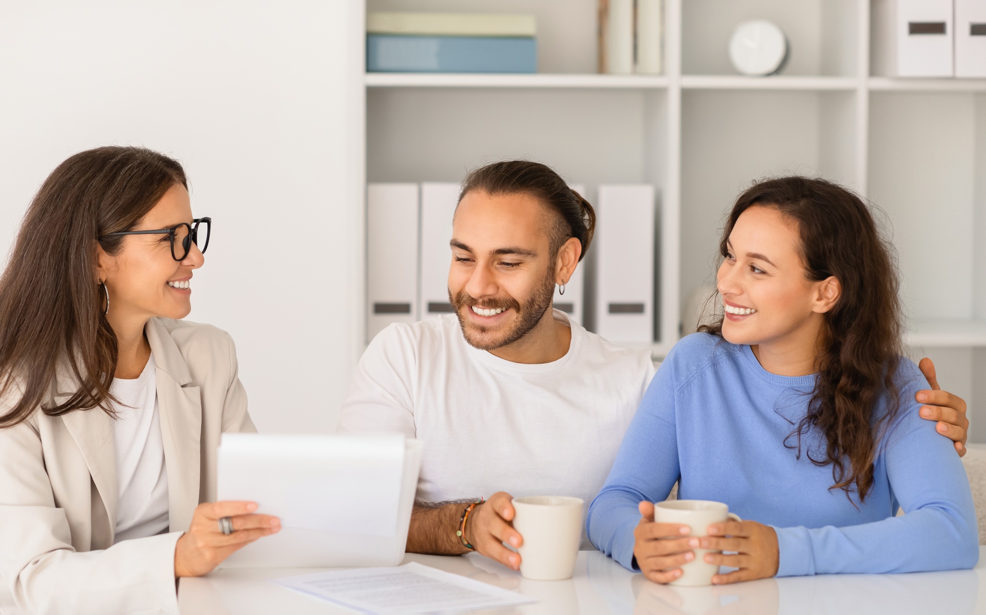 Young couple consults with a lawyer at office